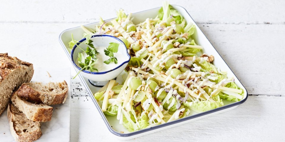 Waldorfsalade Een heerlijke Waldorfsalade van selder en groen appel. De frisse zurige vinaigrette zit in een apart potje en het brood in dikke sneden ligt er langs.